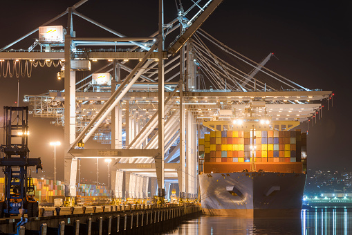 Horizontal color image of a container ship at the port of Los Angeles.
