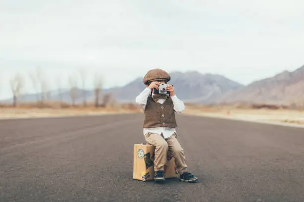 Photo of Young Vintage Boy Photographer with Camera