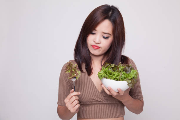 istock Asian woman hate salad. 899687540