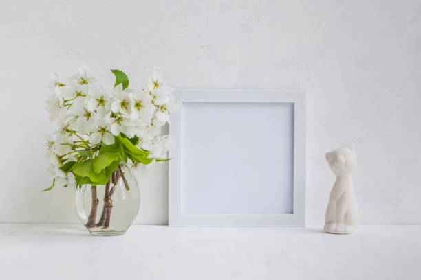 istock Mockup with a white frame and white flowers 899688148