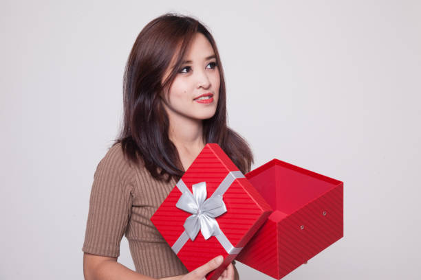 istock Young Asian woman open a gift box. 899690690