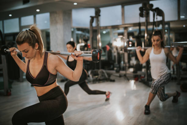 istock Attractive young women exercising weight lifting 899691388