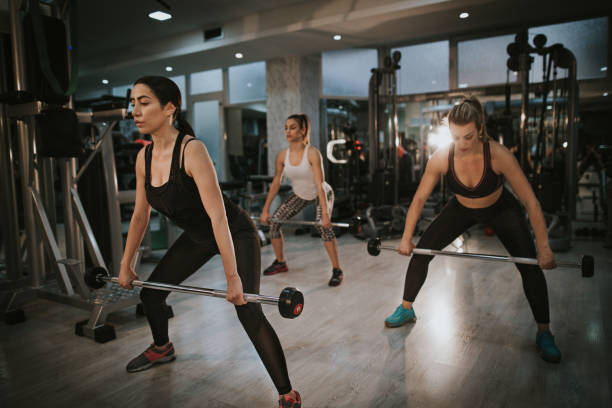 istock Attractive young women exercising weight lifting 899691762