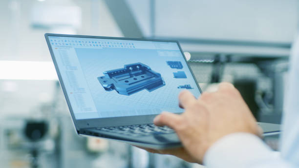 istock Close-up of the Engineer Holding Laptop with CAD Component Model on Screen. In the Background Modern Factory Equipment. 899692816