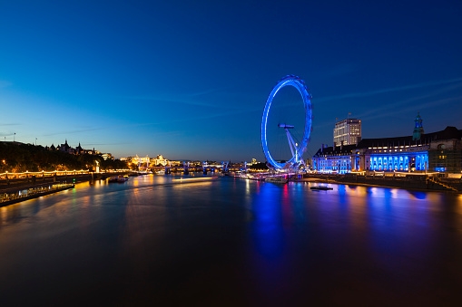 Thames River with view to the City of London and the London Eye with reflection at night