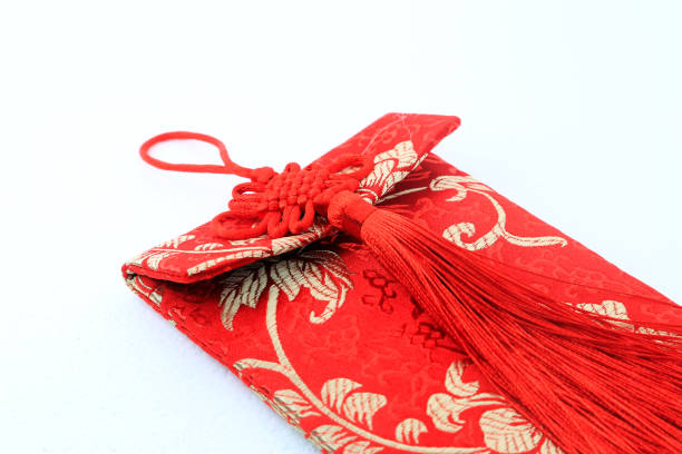 istock Small red bag with Chinese fabric design over white background 899699118