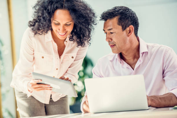 istock Woman showing something on a tablet to her husband 899700866
