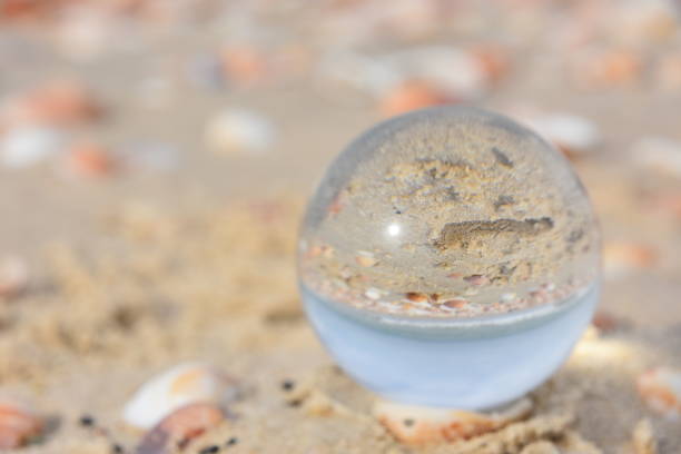 istock glass ball on the beach 899701616