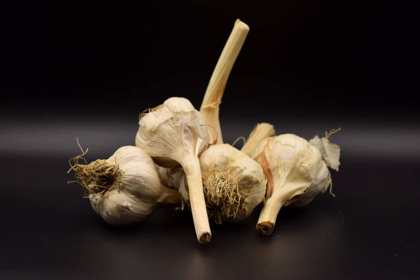 istock Garlic and Onions on a Black Background 899702016