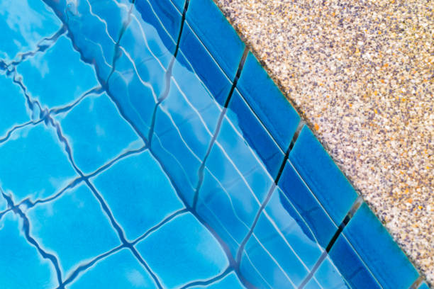 istock Swimming pool with a stone flooring beside it 899704302