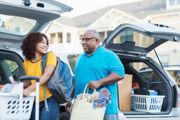 istock African-American father helping daughter move 899704710