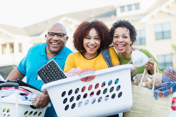 istock African-American parents helping daughter move 899704966