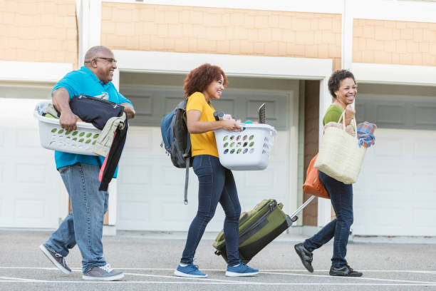 istock African-American parents helping daughter move 899705222