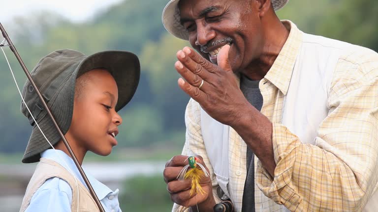 CU PAN Grandfather teaching grandson (8-9) about fly fishing / Richmond, Virginia, USA