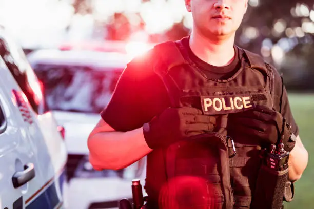 Photo of Hispanic police officer wearing bulletproof vest