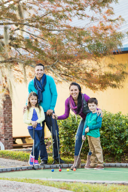 istock Family playing miniature golf 899712358
