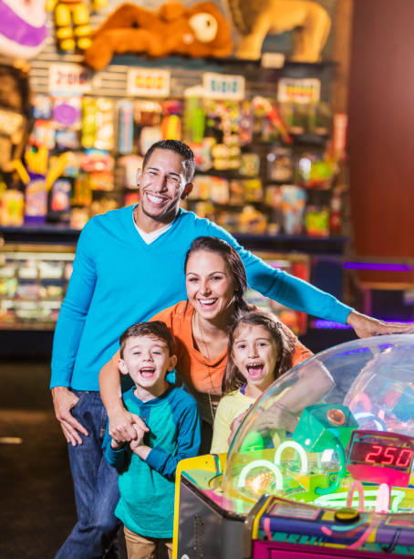 istock Family with two children in amusement arcade 899712496