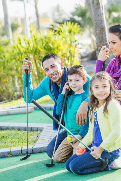 istock Family playing miniature golf 899712498