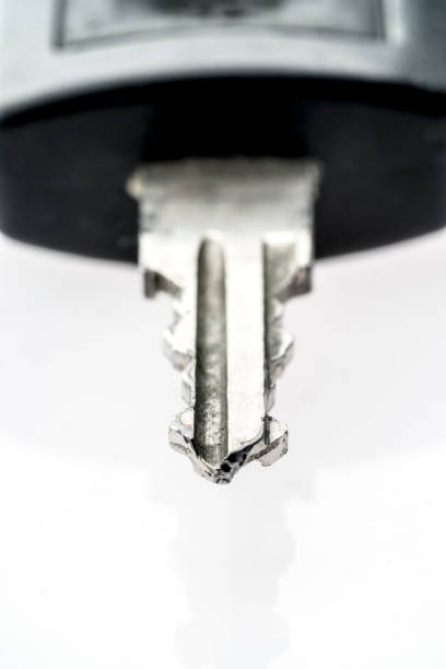istock Old scratched car key on white background 899719108