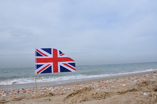 A miniature British flag at the beach