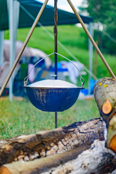 istock a camp-steaky sooty food bowl hanging on a tripod over a fire 899719812