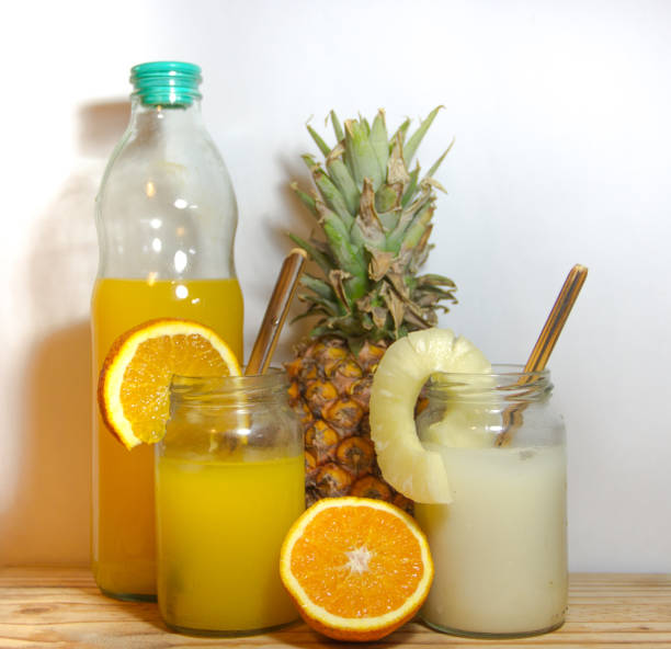 istock Juices smoothies and fresh pineapple and orange drinks with summer fruits 899723574