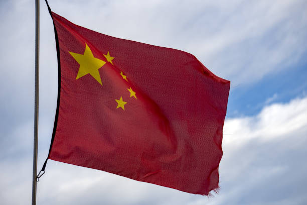 istock waving chinese flag red background and yellow stars 899730752