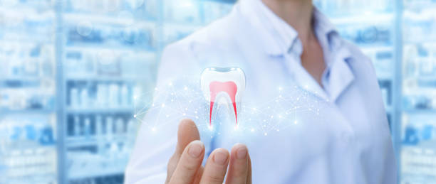 istock Dentist showing tooth model . 899731770