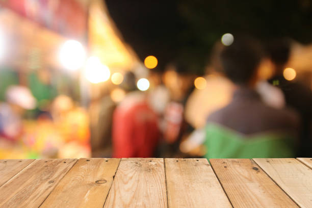 istock Wooden table board on front blurred night street background, copy space for presentation product template 899735840