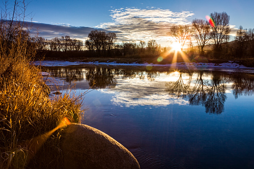 Scenic Eagle River at Sunrise - Landscape in winter with warm sunrise light.