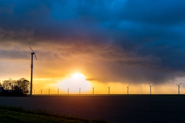 istock Sunset over the windmills on the field 899754348