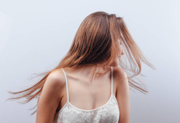 Young woman tossing hair