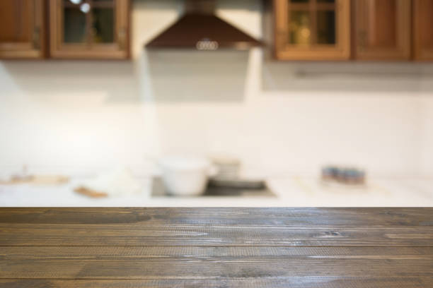 istock Blurred background. Empty wooden tabletop and defocused modern kitchen for display or montage your products. 899757038