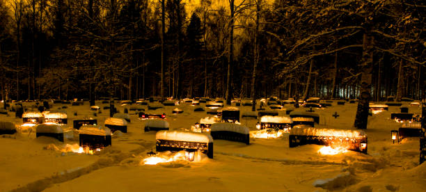 Candle lit snowy cemetery in Christmas time
