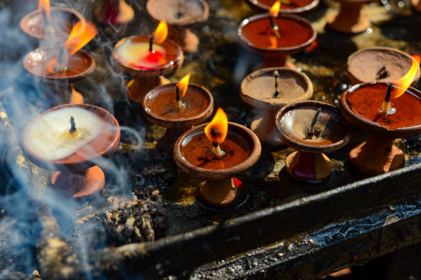 istock burning buddhist candles, ritual puja, India, Nepal 899758804