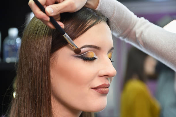 istock The girl makes up eyes in salon 899764266