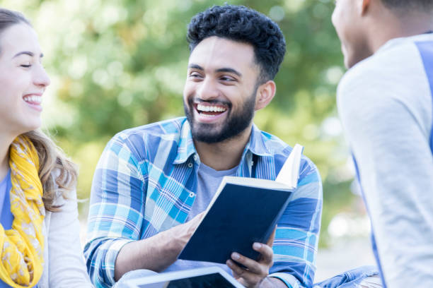 istock Diverse college students studying together outdoors 899767198