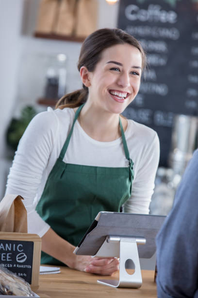 istock Cheerful barista assists customer 899767266