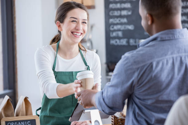 istock Female barista serves male customer 899767290