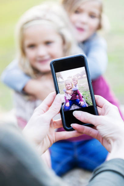 istock Unrecognizable mom take photo of her daughters 899767400