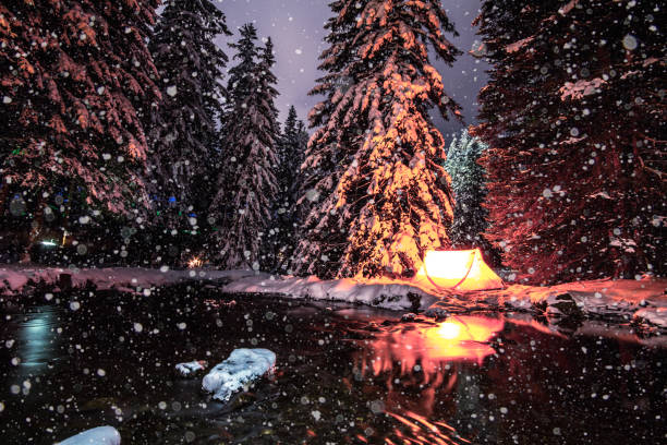winter camping im zelt. geheimnisvolle wald in lenzerheide, schweiz. weihnachts-licht-show - winter stream river snowing stock-fotos und bilder