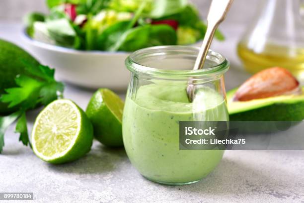 Homemade Avocado Yogurt Dressing In A Vintage Glass Jar Stock Photo - Download Image Now