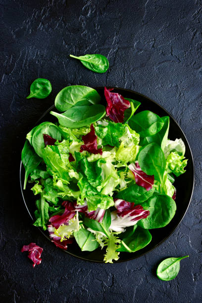 istock Mix salad leaves in a black bowl 899780204