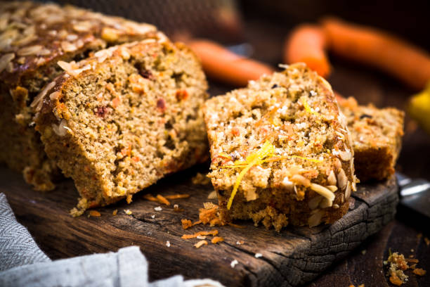 морковный торт нарезанный на деревянной деревенской доске - cake carrot carrot cake dessert стоковые фото и изображения