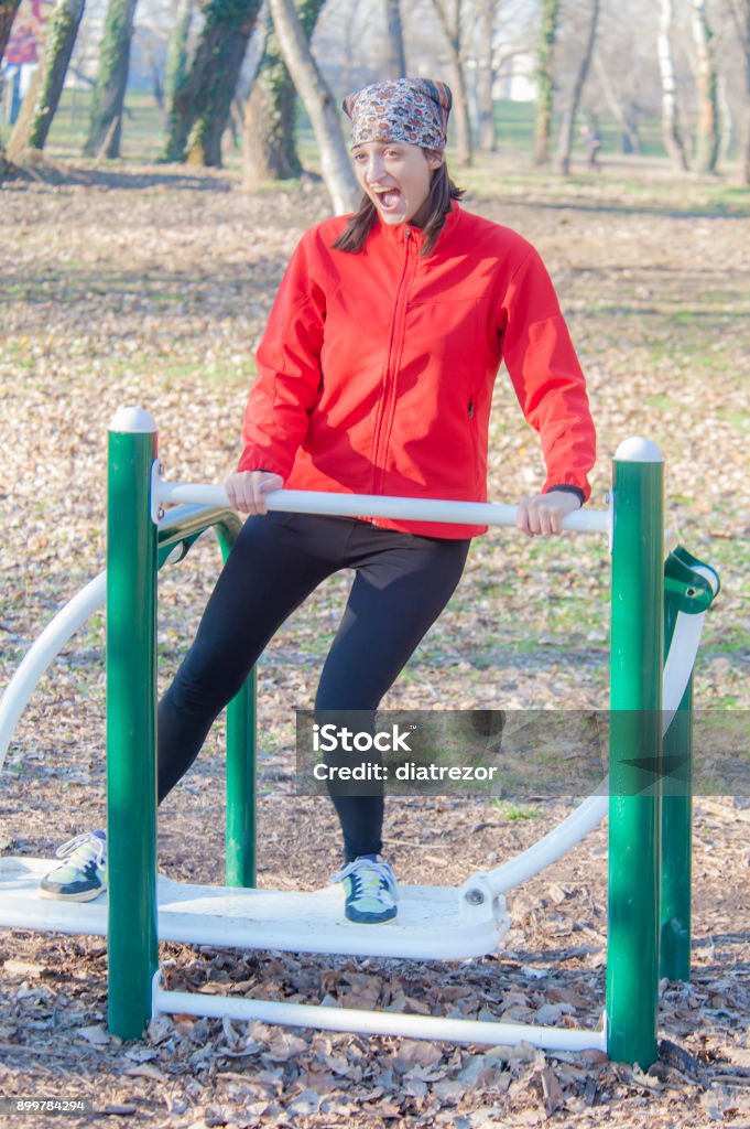 exercising on a machine at the outdoor gym 20-29 Years Stock Photo