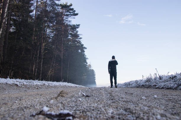istock Man walking on dirt road and talking on smart phone 899784508