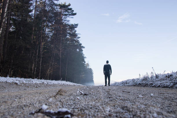 istock Man walking on dirt road 899784688