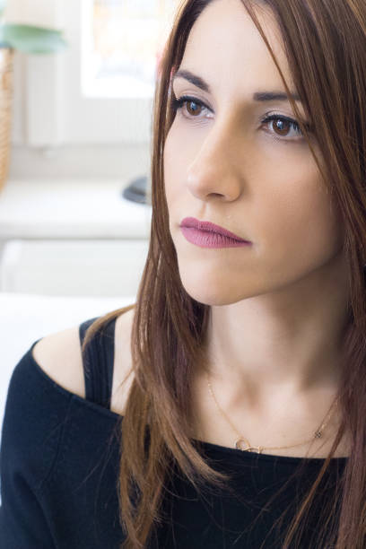 istock Young woman profile view 30s, thinking., indoors. 899805456