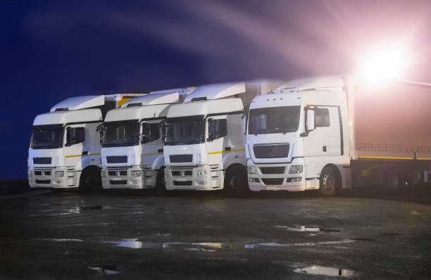 istock trucks at night in parking lot 899819576