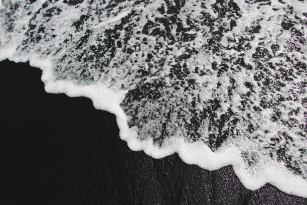 Sea waves on black sand beach